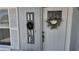 A charming front door with decorative wreaths and the word 'HOME' adds a warm touch at 15106 Sw 38Th Cir, Ocala, FL 34473