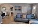 Modern living room with leather sofa, neutral walls, and an open doorway to the adjacent bedroom at 15106 Sw 38Th Cir, Ocala, FL 34473