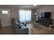 A spacious living room features a modern sofa, stylish coffee table, and ample natural light at 15106 Sw 38Th Cir, Ocala, FL 34473