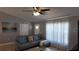 Comfortable living room featuring a modern grey leather sofa, decorative pillows, and neutral decor at 15106 Sw 38Th Cir, Ocala, FL 34473