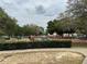 Community playground surrounded by mature trees, creating a shady space for children to play at 15106 Sw 38Th Cir, Ocala, FL 34473