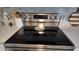 Close up of a stainless steel range with black cooktop and tile backsplash at 15106 Sw 38Th Cir, Ocala, FL 34473
