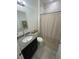 Clean bathroom with a granite vanity, modern fixtures, and a shower-tub combination with decorative curtain at 15954 Sw 55Th Avenue Rd, Ocala, FL 34473