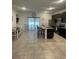 Open-concept kitchen with stainless steel appliances, granite countertops, and a spacious island with bar seating at 15954 Sw 55Th Avenue Rd, Ocala, FL 34473