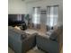 Comfortable living room featuring tile flooring, large windows for natural light, and a neutral color palette at 15954 Sw 55Th Avenue Rd, Ocala, FL 34473