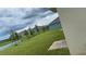Spacious backyard overlooking a pond with a well-maintained lawn and young trees at 167 Eagleview Loop, Davenport, FL 33837