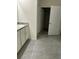 Bathroom featuring a granite countertop vanity, modern hardware, and gray tiled flooring at 167 Eagleview Loop, Davenport, FL 33837