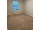 Bedroom with neutral carpet, one window with blinds, white walls, and simple white trim at 167 Eagleview Loop, Davenport, FL 33837