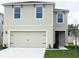 Charming two-story home with a neutral color scheme, a two-car garage, and a well-maintained front lawn at 167 Eagleview Loop, Davenport, FL 33837