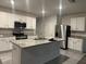 Modern kitchen featuring stainless steel appliances, granite countertops, and ample cabinet space at 167 Eagleview Loop, Davenport, FL 33837