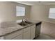 Kitchen featuring granite counters, stainless steel appliances, and a double sink at 167 Eagleview Loop, Davenport, FL 33837