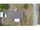 Overhead view of the home with a modest roof, extended porch, and adjacent driveway near nearby trees at 18806 Monroe Ave, Orlando, FL 32820