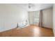 An empty bedroom offers hardwood floors, a window and ceiling fan ready for personalization at 18806 Monroe Ave, Orlando, FL 32820
