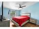 Charming bedroom offers cozy ambiance with ceiling fan, dresser, nightstand, and ample natural light at 18806 Monroe Ave, Orlando, FL 32820