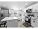 Modern kitchen featuring white cabinets, stainless steel appliances, backsplash, and a kitchen island at 18806 Monroe Ave, Orlando, FL 32820