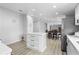 Open concept kitchen area with white cabinets, stainless steel appliances, and an island with quartz countertop at 18806 Monroe Ave, Orlando, FL 32820