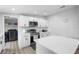 Bright kitchen features white cabinets, stainless steel appliances, and a center island with quartz countertop at 18806 Monroe Ave, Orlando, FL 32820