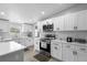 Well-lit kitchen with white cabinets, stainless steel appliances, backsplash, and a kitchen island at 18806 Monroe Ave, Orlando, FL 32820
