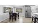 Open concept kitchen with stainless steel appliances, kitchen island, and dining table in natural light at 18806 Monroe Ave, Orlando, FL 32820