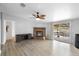 Spacious living room features a brick fireplace, a ceiling fan, and sliding glass doors to a wood deck at 18806 Monroe Ave, Orlando, FL 32820