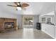Spacious living room features a brick fireplace, a ceiling fan, and sliding glass doors to a wood deck at 18806 Monroe Ave, Orlando, FL 32820