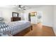 Main bedroom with natural light from windows, closet access, TV, and hardwood floors at 18806 Monroe Ave, Orlando, FL 32820