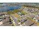 Aerial view of residential area showcasing homes near a community pool, green space, and lake providing an ideal neighborhood setting at 19283 Allium Pl, Orlando, FL 32827