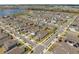 Aerial view of a well-planned residential community featuring a picturesque lake and neatly arranged homes with lush green landscaping at 19283 Allium Pl, Orlando, FL 32827