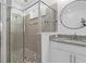 Modern bathroom with a glass shower, tiled walls, and granite countertops at 19283 Allium Pl, Orlando, FL 32827