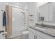 Well-lit bathroom with a shower, tub, granite countertop, and modern fixtures at 19283 Allium Pl, Orlando, FL 32827