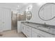 Dual-vanity bathroom with granite countertops, glass shower and tile flooring at 19283 Allium Pl, Orlando, FL 32827