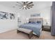 Bright bedroom with a large bed, ceiling fan, and beach-themed decor at 19283 Allium Pl, Orlando, FL 32827