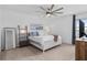 Comfortable bedroom with neutral carpet, ceiling fan, and light-colored walls at 19283 Allium Pl, Orlando, FL 32827