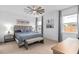 Beautiful bedroom featuring a ceiling fan, neutral carpet and walls, and elegant decor at 19283 Allium Pl, Orlando, FL 32827