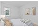 Bright bedroom with a window, carpet, and abstract artwork creates a modern and relaxing atmosphere at 19283 Allium Pl, Orlando, FL 32827
