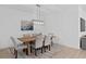 Bright dining room with modern light fixture, dining table and six chairs at 19283 Allium Pl, Orlando, FL 32827