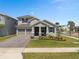 Charming two-story home with a well-manicured lawn, a two-car garage, and inviting entry at 19283 Allium Pl, Orlando, FL 32827