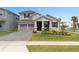 Charming home with a well-manicured lawn and a two-car garage at 19283 Allium Pl, Orlando, FL 32827