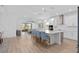 Open-concept kitchen and living area with a large island, bar seating, and modern finishes, perfect for entertaining at 19283 Allium Pl, Orlando, FL 32827
