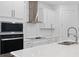Close-up of a modern kitchen with stainless steel appliances, quartz countertops, and a sleek design for cooking enthusiasts at 19283 Allium Pl, Orlando, FL 32827