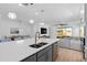 Open-concept kitchen with stainless steel appliances, quartz countertops, and eat-in dining at 19283 Allium Pl, Orlando, FL 32827