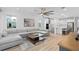 Open-concept living room with kitchen featuring a large sectional sofa and modern appliances at 19283 Allium Pl, Orlando, FL 32827