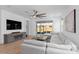 Spacious living room featuring a large sectional sofa and sliding glass doors to the patio at 19283 Allium Pl, Orlando, FL 32827