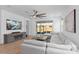 Spacious living room featuring a large sectional sofa and sliding glass doors to the patio at 19283 Allium Pl, Orlando, FL 32827