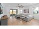 Cozy living room featuring a large sectional sofa and sliding glass doors to the patio at 19283 Allium Pl, Orlando, FL 32827