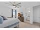 Bright main bedroom features ceiling fan, TV, and ensuite bathroom with walk-in closet at 19283 Allium Pl, Orlando, FL 32827