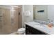 Neutral-toned bathroom featuring granite counters, a glass-enclosed shower, and decorative accents at 1995 Majorca Dr, Kissimmee, FL 34747