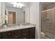 Well-lit bathroom featuring double sinks, granite countertops, and a glass-enclosed shower at 1995 Majorca Dr, Kissimmee, FL 34747
