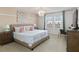 Serene bedroom with neutral decor, a chandelier, and plenty of natural light at 1995 Majorca Dr, Kissimmee, FL 34747