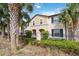 Charming townhome with a beautiful exterior, well-manicured landscaping, and mature palm trees at 1995 Majorca Dr, Kissimmee, FL 34747